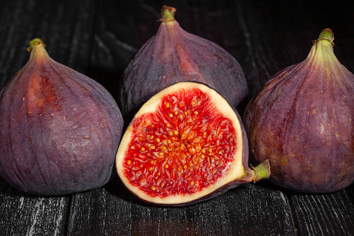 sliced figs on wood background