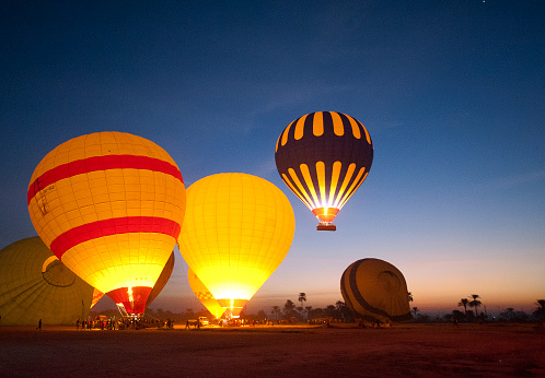 large hot air balloon is in the farm of santa fe de antioquia. it is inflated with fire to achieve its elevation and have family fun