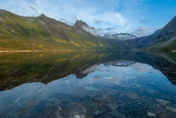 istock Tranquil Mountain Lake Reflection at Dusk in a Serene Valley 1922283698