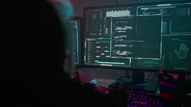 Hacker watches server decoding process on computer monitors