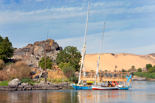 The Cataracts, Aswan, Nile River, Egypt. The River Nile has always and continues to be a lifeline for Egypt. Trade, communication, agriculture, water and now tourism provide the essential ingredients of life - from the Upper Nile and its cataracts, along its fertile banks to the Lower Nile and Delta. In many ways life has not changed for centuries, with transport often relying on the camel on land and felucca on the river