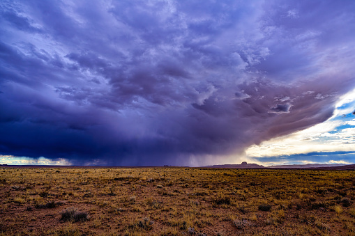 Large Storm with Ominous Skies Over Desert Landscape - Scenic view with dramatic steel blue dark clouds overhead.