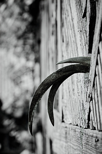 Abstract rural scenery illustrating three reaping hooks