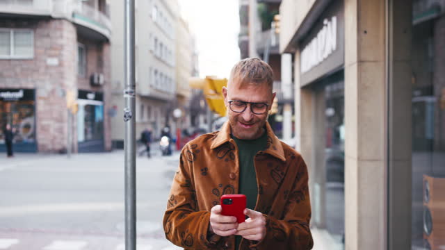 Mature man using smart phone in urban district