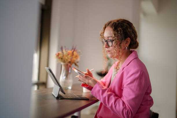 istock Businesswoman using mobile phone at work in her office. 1922333370