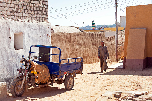 Nubian Village backstreet, The Cataracts, Aswan, River Nile, Egypt. The River Nile has always and continues to be a lifeline for Egypt. Trade, communication, agriculture, water and now tourism provide the essential ingredients of life - from the Upper Nile and its cataracts, along its fertile banks to the Lower Nile and Delta. In many ways life has not changed for centuries, with transport often relying on the camel on land and felucca on the river