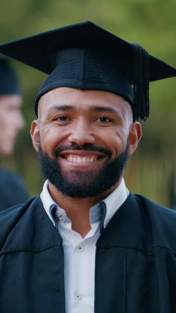 Man, face and graduation at university, outdoor and smile with pride, achievement or goal in education. Student, graduate or person in portrait, cap and gown at college, campus and excited for future