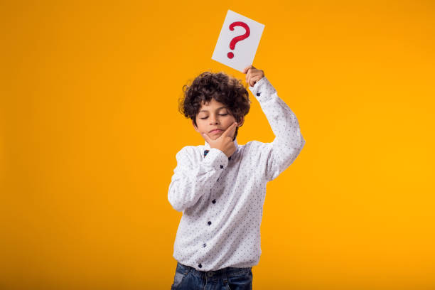 istock Child boy holding question mark card. Brainstorming and choice concept 1922365613