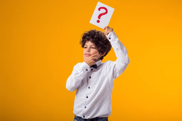 istock Child boy holding question mark card. Brainstorming and choice concept 1922365614