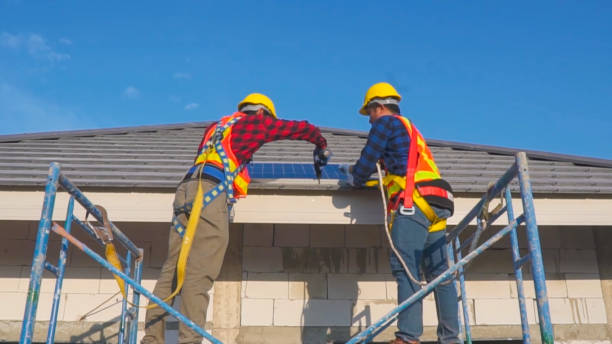 istock Two technicians installing solar panels on the roof of a house. 1922369497
