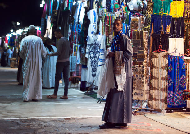Trader awaits custom in Kom Ombo bazaar, Kom Ombo, River Nile, Egypt stock photo