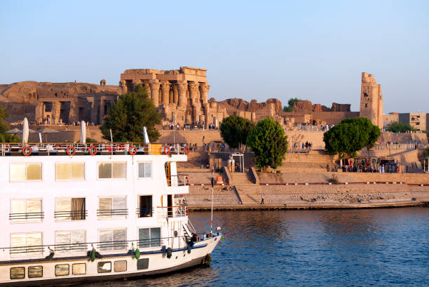 Double temple of Kom Ombo and river cruise boat, River Nile, Egypt, stock photo