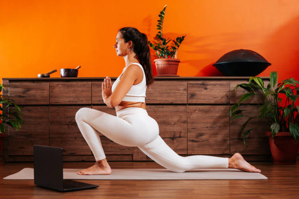 istock Woman doing yoga online at home. 1922382032