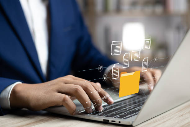 istock Document management system concept (DMS), Businessman working laptop virtual screen icons folder and document management system, Software for archiving, Searching and managing files corporate document 1922382594