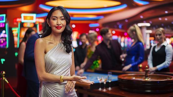 Ecstatic woman winning on a slot machine in a casino.