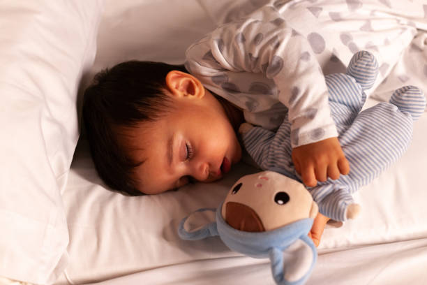 istock Baby sleeping with her stuffed animal seen from above 1922389998