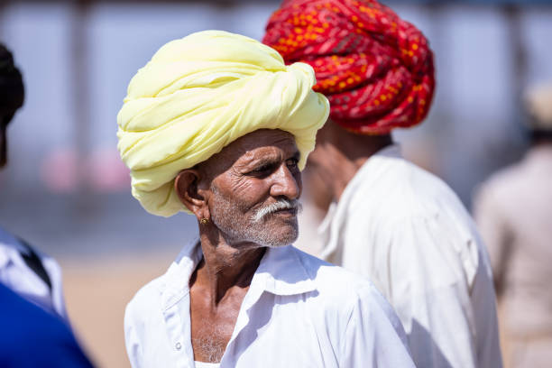 Delhi, The Red Fort - September 21, 2022: Indian tourist visit The Red Fort. A male follower of Sikhism in a traditional turban