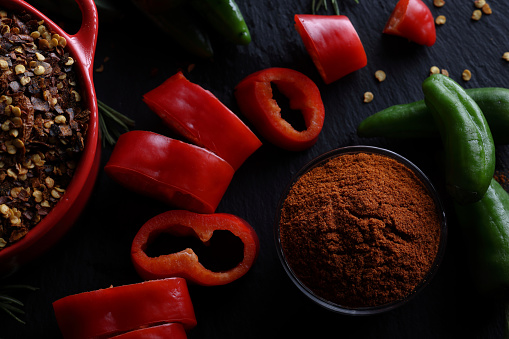 Top view of chilli peppers isolated on the brown textured wood background