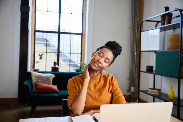 istock Tired businesswoman massaging her neck while working in her office 1922406929