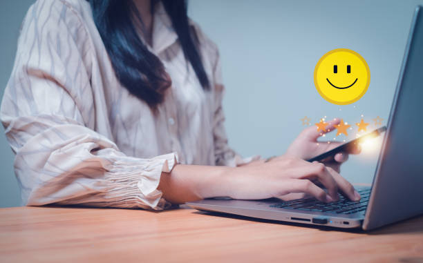 istock Woman hand doing online assessment on satisfaction level, let customer improve and develop customer satisfaction concept, smiley face icon, positive emotion and five stars with copy space. 1922418211