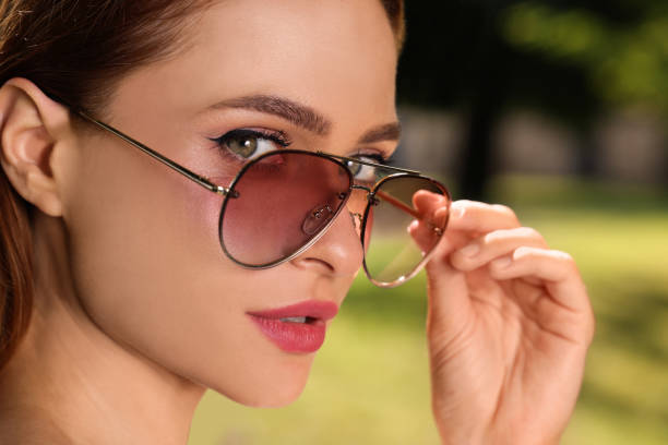 istock Beautiful woman in sunglasses outdoors on sunny day, closeup 1922425757