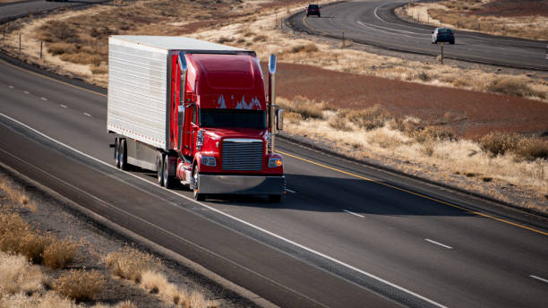 istock A red semi-truck with some paint missing hauling a dry van 1922427881