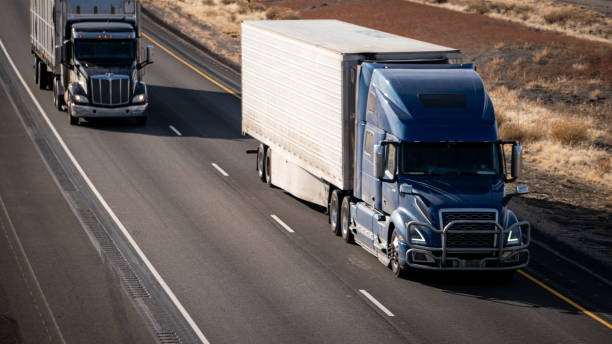 istock A blue semi-truck passing a slower truck on the interstate 1922428434