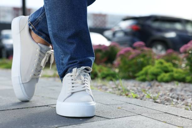 istock Man wearing stylish sneakers outdoors, closeup. Space for text 1922434245