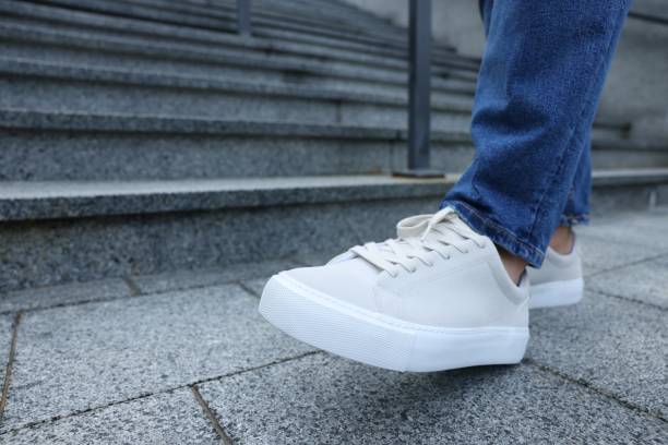 istock Man walking in stylish sneakers outdoors, closeup. Space for text 1922434752