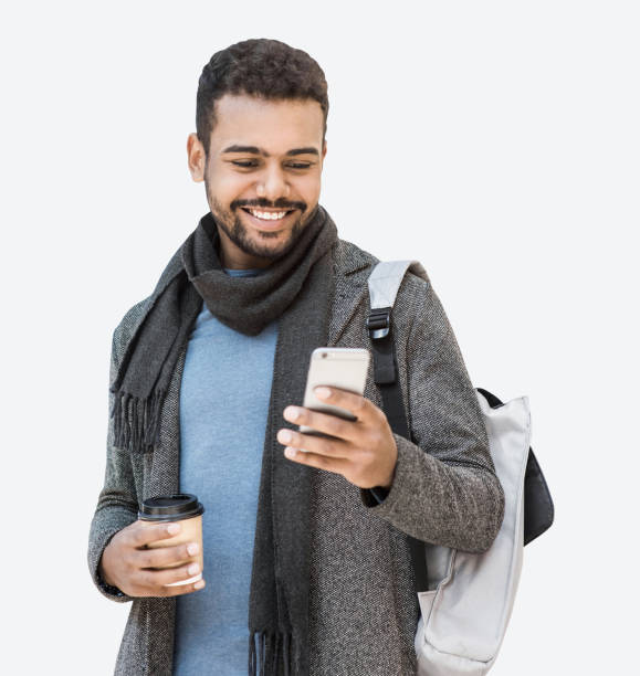 istock Handsome man wearing warm clothes using smartphone, isolated 1922434760