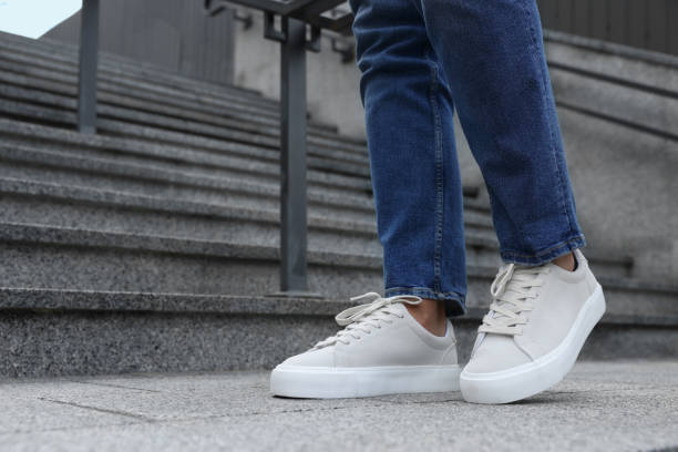 istock Man wearing stylish sneakers outdoors, closeup. Space for text 1922437973