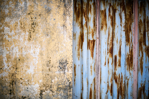 Urban details in Italian town: Wall and rusty door