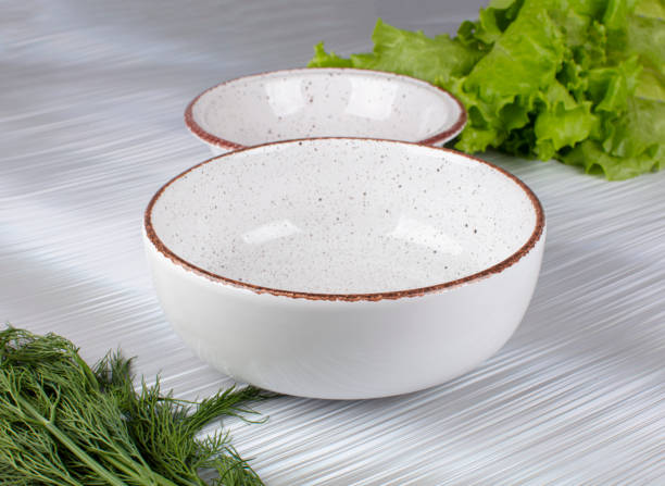 istock Ceramic clay plate with dark edging on gray background 1922443248