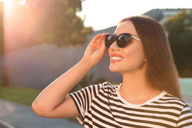 istock Beautiful smiling woman in sunglasses outdoors, space for text 1922452197