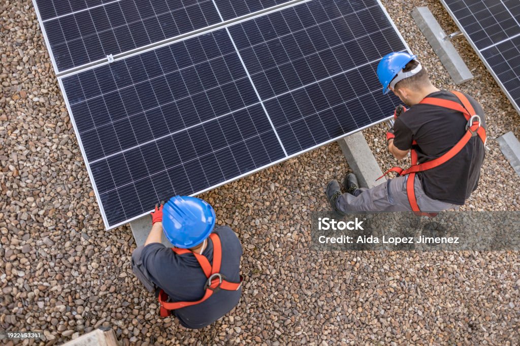 Transporting Solar Aerial View Of Two Engineers Transporting And Installing A Solar Panel ...