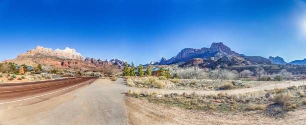 istock Panoramic picture of a lonely road through mountainous desert 1922457077