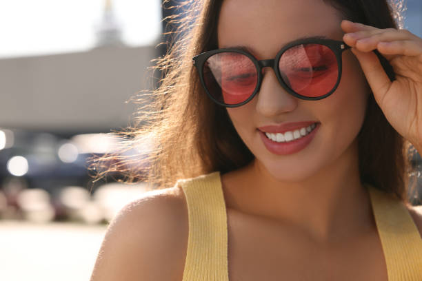 istock Beautiful smiling woman in sunglasses outdoors, space for text 1922458095