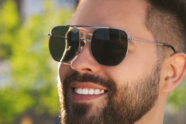 istock Handsome smiling man in sunglasses outdoors, closeup. Space for text 1922458112