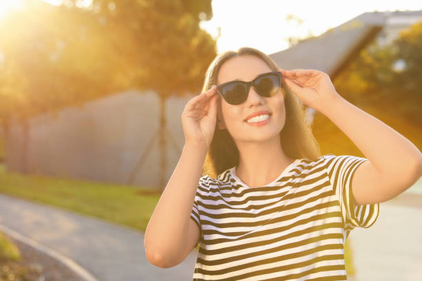 istock Beautiful smiling woman in sunglasses outdoors, space for text 1922460745