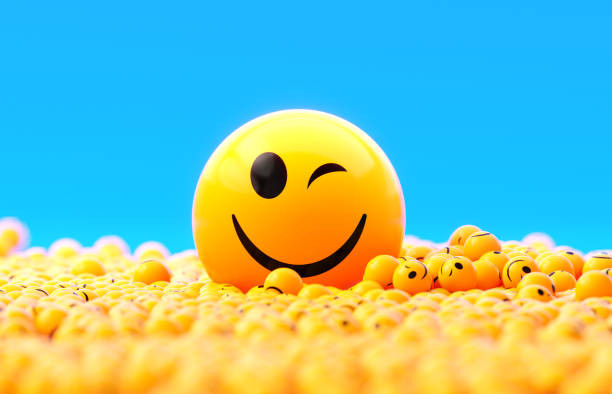 istock Yellow Spheres Textured With Happy Face Emoji On Blue Background 1922473163