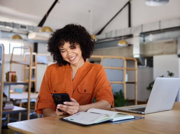 istock Young businesswoman smiling at a text while working in an office 1922492555