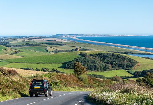 Car on the road to Chesil Beach in Dorset