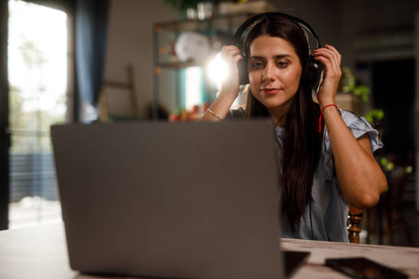 istock Young woman joining a video call meeting when working from home 1922531020