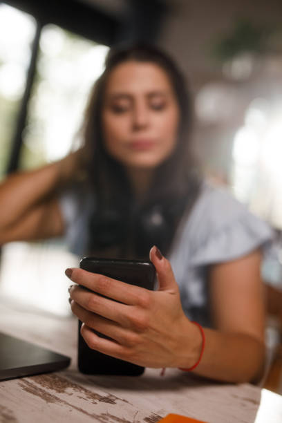 istock Young woman checking her text messages on smart phone when working 1922531602