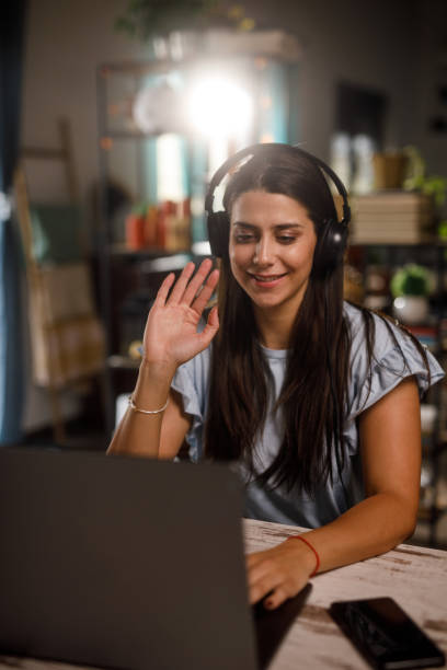 istock Young woman joining a video call meeting when working from home 1922532138
