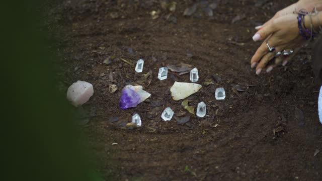 Close up of a person's hand meditating with crystal rocks on the river bank in the Salto Encantado park located in Misiones, Argentina. Misiones Wild Flora and Fauna Conservation Area.