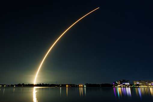 A United Launch Alliance Atlas V rocket heads to space from Cape Canaveral carrying a payload of an National Reconnaissance Office intelligence gathering satellite. The launch occurred just a few minutes after the sunset and the sun lit up the contrail as it rose.  Taken at Jetty Park in Cape Canaveral, a public viewing area.