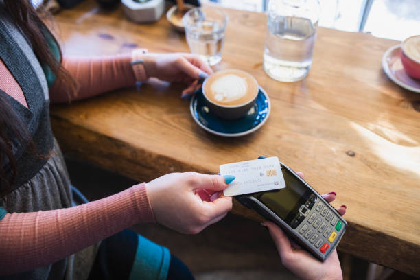 istock Customer at a cafe paying with card. 1922558557