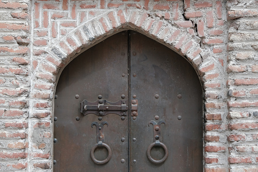 Wrought iron door. metal door in an old medieval temple. medieval background