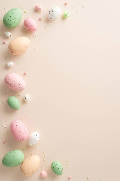 istock Seasonal Joy Display: Top-view vertical photo showcasing traditional Easter eggs, and scattered colorful sprinkles against a pastel beige backdrop with space for text or ads 1922566591